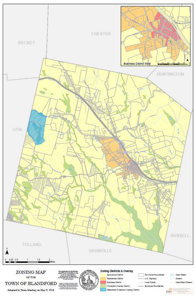 Zoning Map of the Town of Blandford, adopted by Town Meeting on May 6, 2019. Most of the town is shaded pale yellow as the Agricultural District. Near the middle of the town an area of Residential District, in orange, surrounds the center, and the Business District, in red, lies at its southeastern edge beside the Massachusetts Turnpike, which crosses the town from northwest to southeast; an inset in the upper right corner, the Business District Inset, shows the center at a larger scale. The Watershed Protection Overlay District, hatched blue, covers an area on the western boundary with Otis, and the Floodplain Overlay District, hatched green, follows streams and water bodies across the town, with its largest area in the southeast. Tax parcel boundaries, the highway, local roads, streams, and the neighboring towns of Becket, Chester, Huntington, Russell, Granville, Tolland, and Otis are drawn, with a scale bar in miles, a north arrow, the Town seal, and a legend of the districts and overlays.